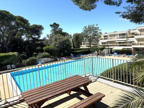 un banc en bois installé à côté d'une piscine dans l'établissement La Passiflore, à Saint-Raphaël