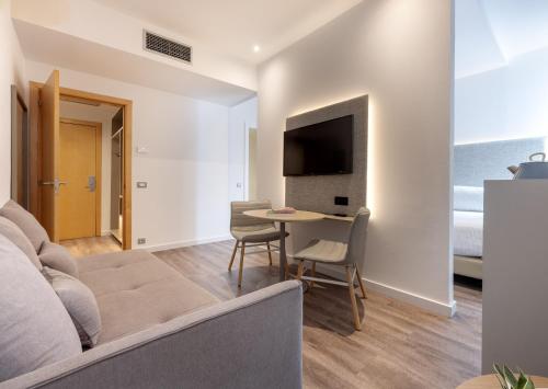 a living room with a couch and a table at INNSiDE by Meliá Barcelona Aeropuerto in El Prat de Llobregat