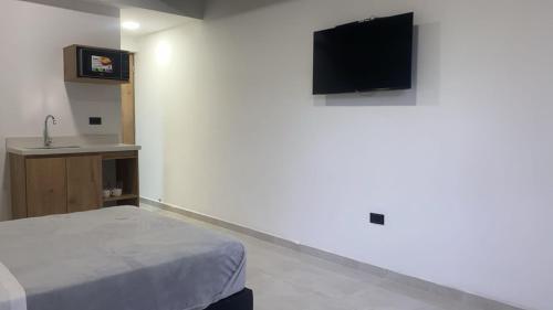 TV a/nebo společenská místnost v ubytování Nook Apartamentos en el corazón de Medellín
