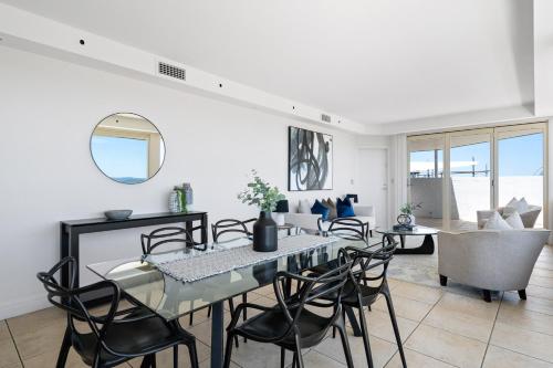 a dining room with a table and chairs at South Head - Premier Penthouse w Amazing Views in Sydney