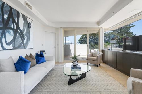 a living room with a couch and a table at South Head - Premier Penthouse w Amazing Views in Sydney