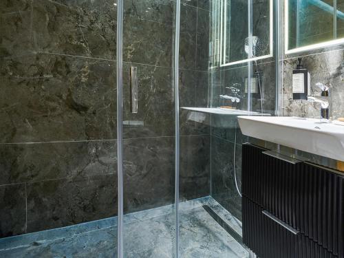 a bathroom with a shower and a sink at Thank You Hotel Sultanahmet in Istanbul