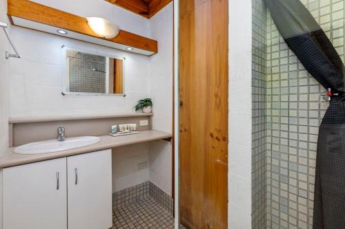 a bathroom with a sink and a shower at 23 Cottesloe Steps to beach - sleeps 3 NO WIFI in Perth