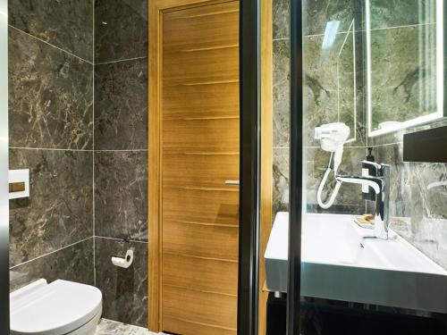 a bathroom with a toilet and a sink at Thank You Hotel Sultanahmet in Istanbul