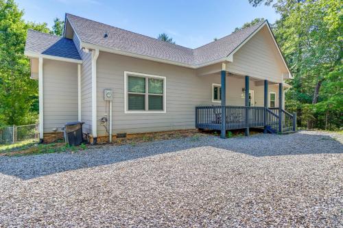 a house with a gravel driveway in front of it at Hike, Fish and Kayak Murphy Gem with Deck and Fire Pit in Murphy