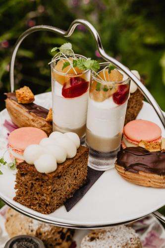 a plate of food with sandwiches and two drinks at Mallyan Spout Hotel in Goathland