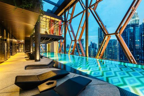 a swimming pool in a building with a city skyline at Scarletz suites klcc Bukit Bintang by lulu in Kuala Lumpur