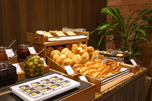 a buffet with various pastries and other foods on a table at Rado Hotel - Quintanas in Trujillo
