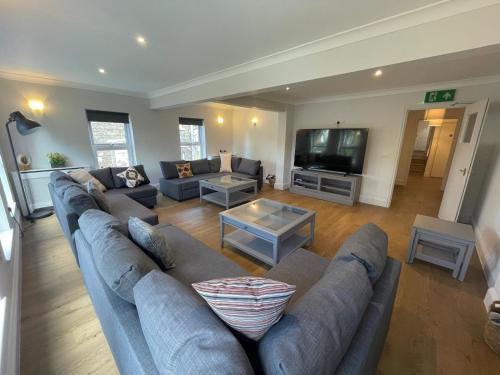 a living room with a couch and a tv at Amber House in Gorleston-on-Sea