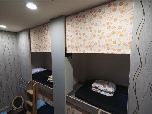 a couple of bunk beds in a room at 綠島 閱光海背包輕旅 體驗自潛 導潛 船票代訂Readingbackpack in Green Island