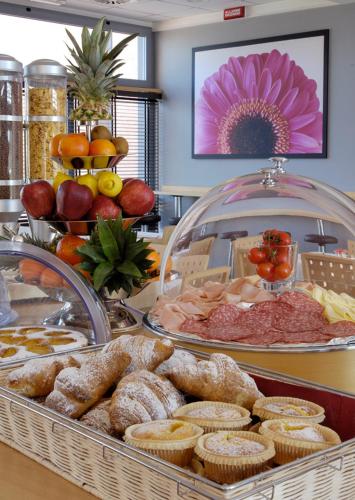 a buffet filled with different types of food on a table at Executive Hotel in Forlì