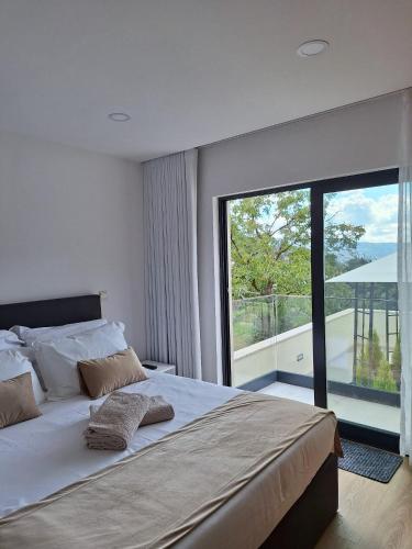 a bedroom with a large bed and a large window at Gerês Valley in Geres