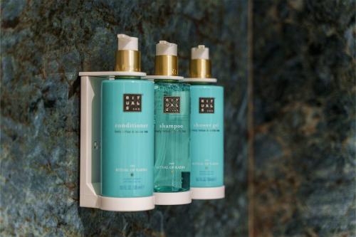 a group of four bottles of soap on a wall at Spirit Hotel Ciudad de Burgos in Rubena