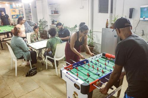 a group of people playing a game of foosball at Summer Hostel in Palolem