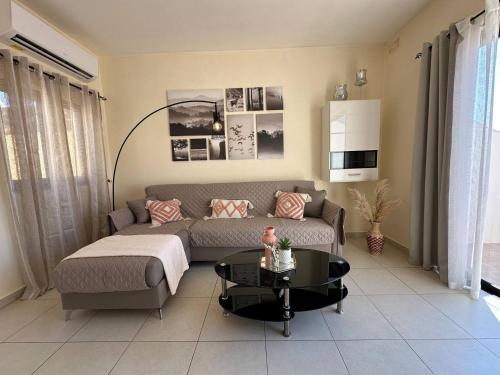 a living room with a couch and a table at Radiant 2BED penthouse Mellieha!! by Homely in Ix-Xagħra taʼ Barra