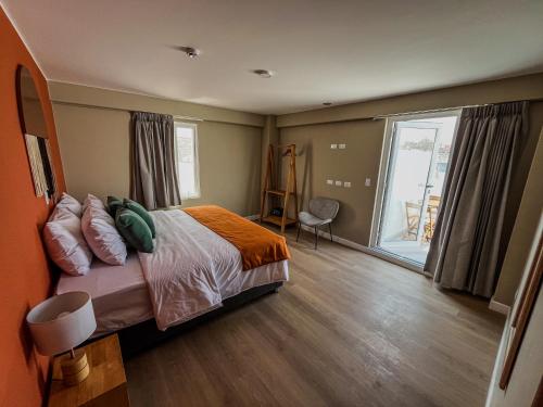 a bedroom with a bed and a large window at Viajero Arequipa Hostel in Arequipa