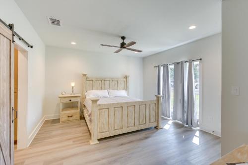 a bedroom with a bed and a ceiling fan at Lake Palestine Vacation Rental - Steps to Water! in Coffee City