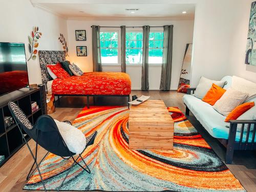 a living room with a bed and a couch at Cozy Guest House Studio Apartment in Greensboro