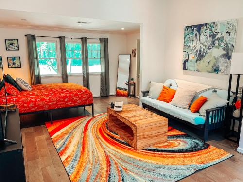 a living room with a bed and a couch at Cozy Guest House Studio Apartment in Greensboro