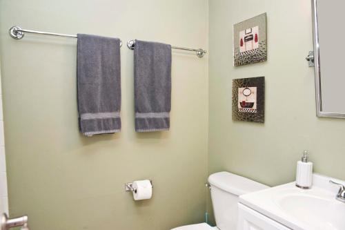 a bathroom with blue towels and a sink at 3 Bedrooms 2 Baths Pool Home available for LONGER STAYS!!! in Port Saint Lucie