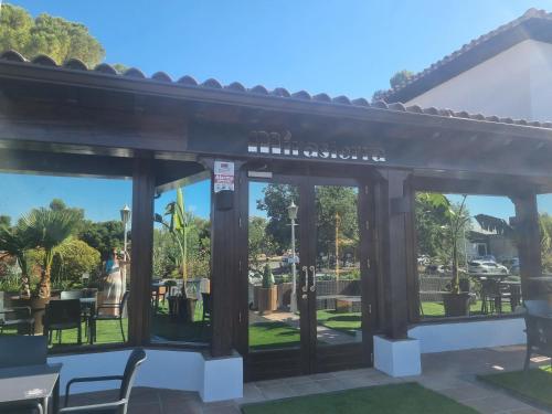 a pergola with a view of a park at Hotel Boutique Mirasierra in Villacañas