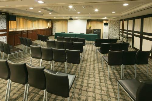 a conference room with chairs and a podium in the middle at Cambridge Tainan Hotel in Tainan