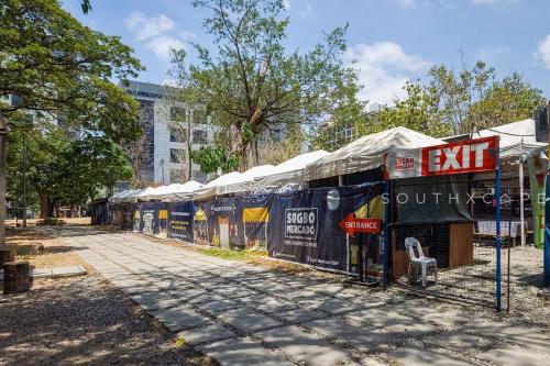 a row of stalls with umbrellas on a street at Furnished 1-Bedroom in Avida Towers Riala, Cebu IT Park with Fast WiFi, Netflix, Pool and More in Mabolo