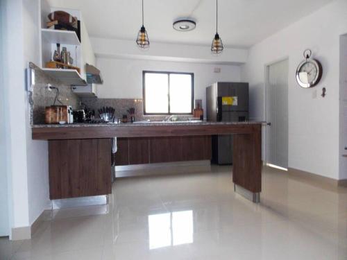 a large kitchen with a large counter in a room at Cañaveral Del Mar 1 Quiet and extremally relaxing! in San Felipe de Puerto Plata