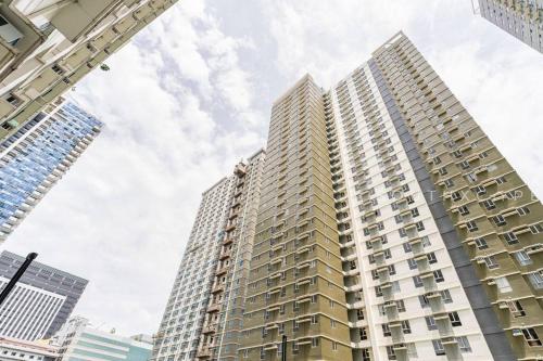 a tall apartment building in a city at Furnished 1-Bedroom in Avida Towers Riala, Cebu IT Park with Fast WiFi, Netflix, Pool and More in Mabolo