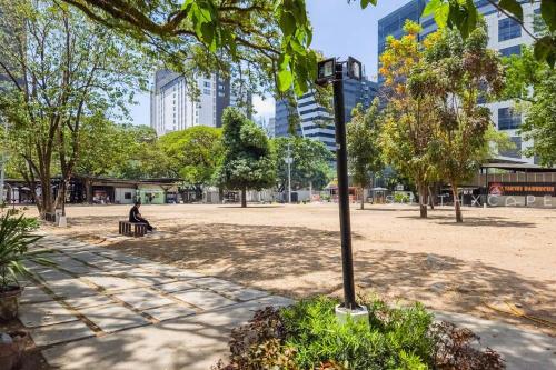 a person sitting on a bench in a park at Furnished 1-Bedroom in Avida Towers Riala, Cebu IT Park with Fast WiFi, Netflix, Pool and More in Mabolo