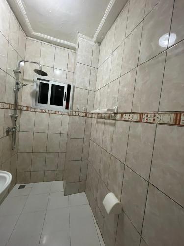 a bathroom with a shower and a sink at Cheb's House in Abidjan