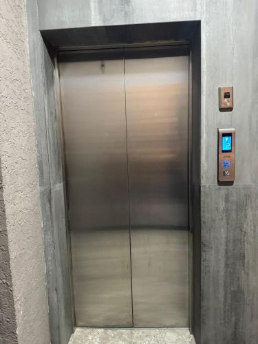 a metal elevator door in a building at Marshall Gudauri Apartment in Gudauri