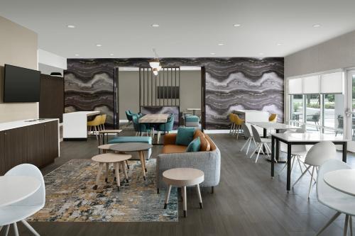 a dining room with tables and chairs at TownePlace Suites Jacksonville Airport in Jacksonville
