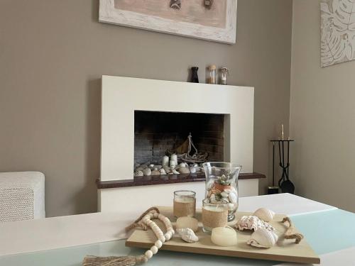 a living room with a fireplace with shells on a table at Garden House in Ierápetra