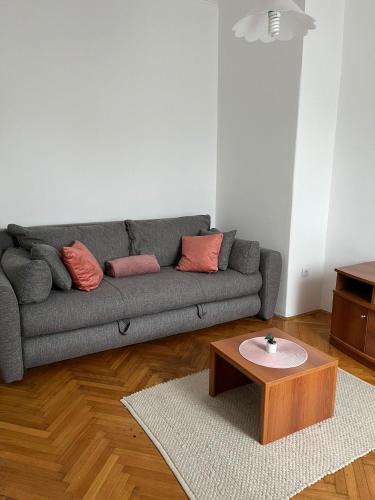 a living room with a couch and a coffee table at Hotel Vlasina - Vlasinsko jezero in Lujinska Mala