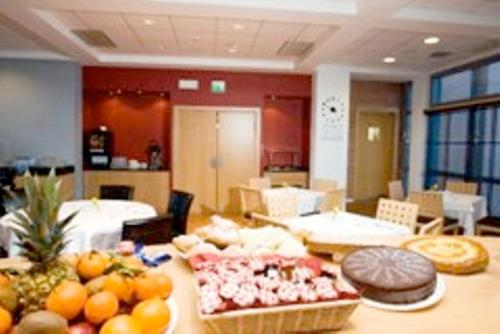 a room with a table with food on it at Executive Hotel in Forlì