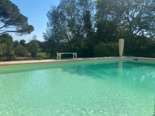 a large pool of water with a table in it at Mes nuits au château au domaine du pressoir in Pierrefeu-du-Var