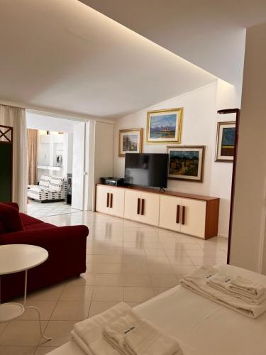 a living room with a couch and a tv at Villa Aurea in Ispica