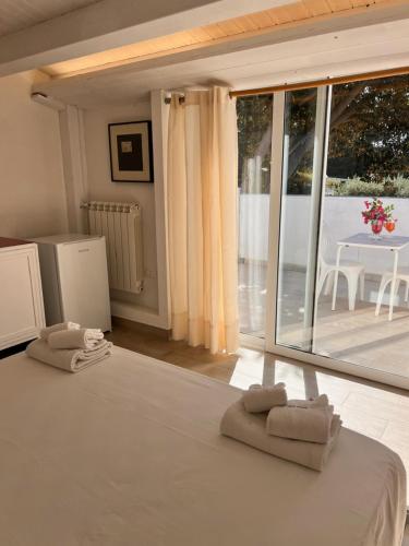 a bedroom with a bed with two towels on it at Villa Aurea in Ispica