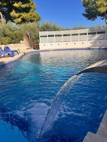 a pool with a water fountain in a yard at Villa Aurea in Ispica