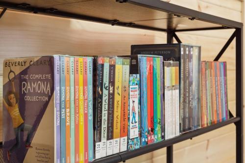 a shelf full of books on a book shelf at Baby Bear Den in Gatlinburg