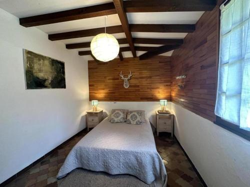 a bedroom with a bed and two night stands with lamps at La bergerie de lesbordes in Lestajaou