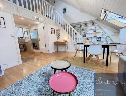 un salon avec une table et des chaises et un escalier dans l'établissement Chez Lou-Poitiers Hyper Centre-Proche Parking-LaConciergerie, à Poitiers