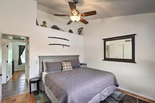 a bedroom with a bed and a ceiling fan at East Tucson House with Private Backyard and Fire Pit in Tucson