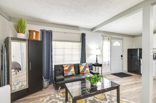 a living room with a couch and a glass table at Greenwood Studio Cottage Less Than 1 Mi to Downtown! in Greenwood
