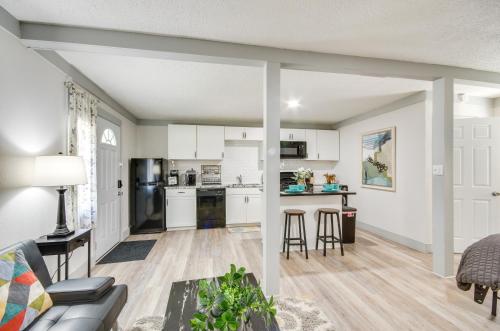 a living room with a couch and a kitchen at Greenwood Studio Cottage Less Than 1 Mi to Downtown! in Greenwood
