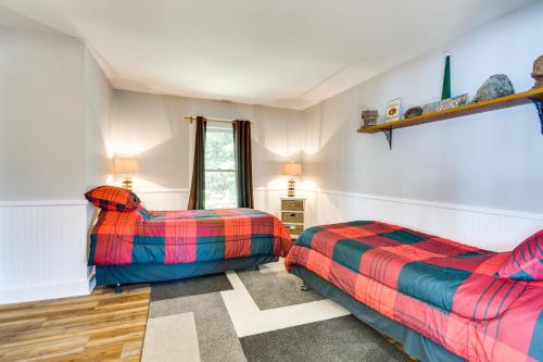 a bedroom with two beds and a window at Waterfront Getaway on Sodus Bay Prime Location! in North Rose