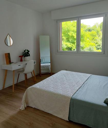 a bedroom with a bed and a desk and a window at el'Gio Feel at Home in Pordenone