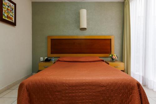 Ένα ή περισσότερα κρεβάτια σε δωμάτιο στο Hotel Qualitel Centro Histórico