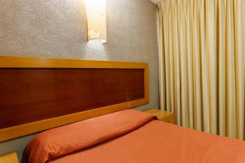Ένα ή περισσότερα κρεβάτια σε δωμάτιο στο Hotel Qualitel Centro Histórico